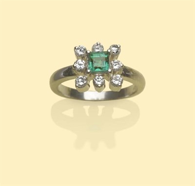 Lot 502 - An Emerald and Diamond Cluster Ring, the square step cut emerald within a border of eight...