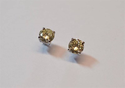 Lot 505 - A Pair of 18 Carat White Gold Diamond Solitaire Stud Earrings, the round brilliant cut diamonds...