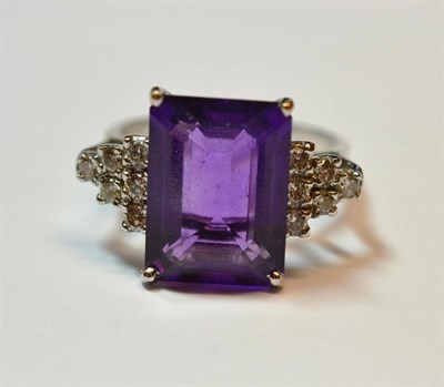 Lot 506 - A 14 Carat White Gold Amethyst and Diamond Ring, the oblong step cut amethyst in a white corner...