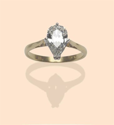 Lot 519 - A Diamond Solitaire Ring, the pear cut diamond in a white four claw setting, to a yellow...