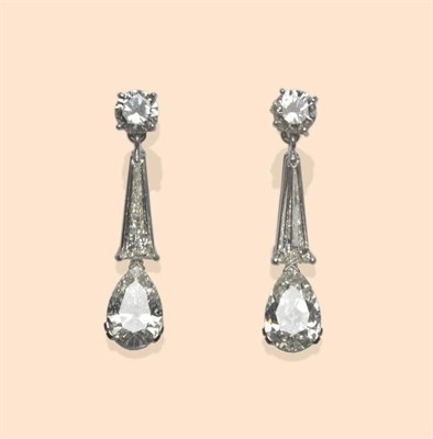 Lot 521 - A Pair of Art Deco Style Diamond Drop Earrings, comprising a round brilliant cut diamond stud,...