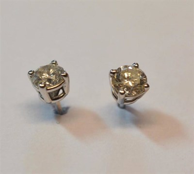 Lot 524 - A Pair of 14 Carat White Gold Diamond Solitaire Stud Earrings, the round brilliant cut diamonds...