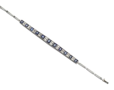 Lot 531 - An Art Deco Sapphire and Diamond Bracelet, oblong step cut sapphires alternate with graduated pairs