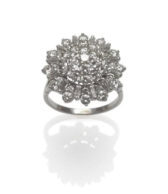 Lot 534 - A Diamond Cluster Ring, of unusual form, the domed centre set with round brilliant cut diamonds...