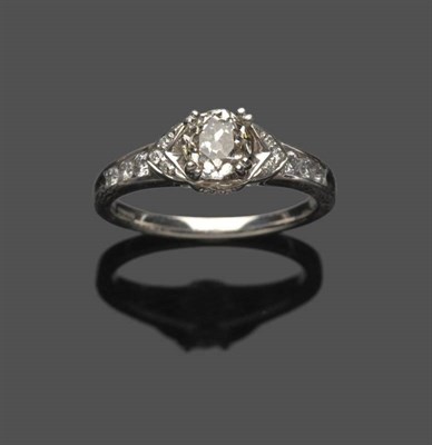 Lot 550 - An 18 Carat White Gold Diamond Ring, an old cut diamond in a four claw setting, over diamond...