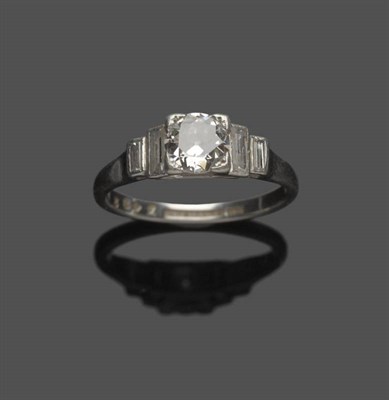 Lot 553 - An Art Deco Diamond Ring, the central old cut diamond with pairs of graduated baguette cut diamonds