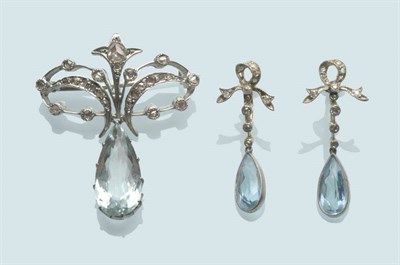 Lot 567 - An Aquamarine and Diamond Brooch, rose cut diamonds in a scroll motif suspend a pear cut...