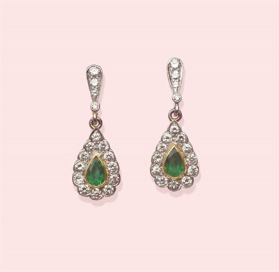 Lot 572 - A Pair of 18 Carat Gold Emerald and Diamond Drop Earrings, a pear cut emerald in a yellow...