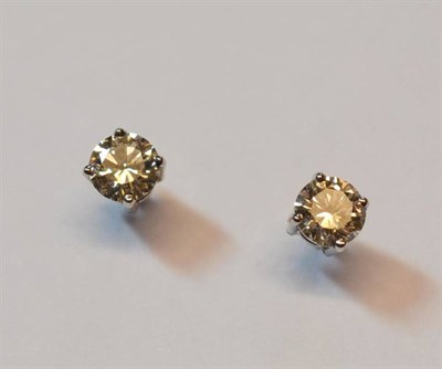 Lot 585 - A Pair of Diamond Solitaire Earrings, a round brilliant cut diamond in a white four claw...