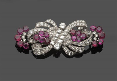 Lot 589 - A Ruby and Diamond Double Clip Brooch, circa 1920, of scroll form, set throughout with...