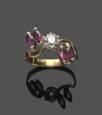 Lot 597 - A Diamond and Ruby Ring, an old cut diamond in white claws within pairs of marquise cut rubies to a