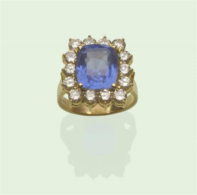 Lot 606 - An 18 Carat Gold Sapphire and Diamond Cluster Ring, the mixed cushion cut sapphire within a...