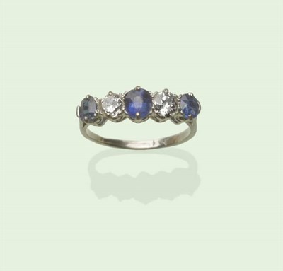 Lot 608 - A Sapphire and Diamond Five Stone Ring, alternating oval cut sapphires and old cut diamonds in...