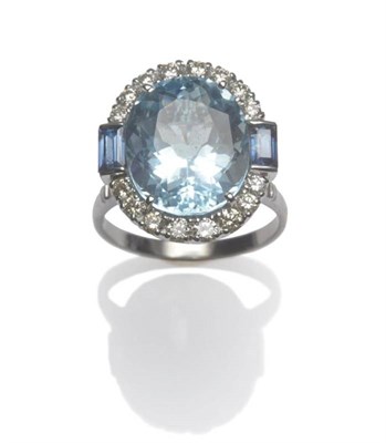 Lot 622 - An 18 Carat White Gold Aquamarine, Sapphire and Diamond Ring, the oval cut aquamarine within a part