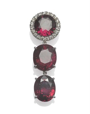 Lot 626 - An 18 Carat White Gold Garnet and Diamond Pendant, a round mixed cut garnet within a border of...