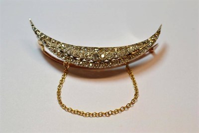 Lot 630 - A Diamond Crescent Brooch, set throughout with three rows of old cut and rose cut diamonds, in...