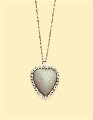 Lot 634 - An Opal and Diamond Pendant, a heart shaped cabochon opal in a white collet setting, within a...