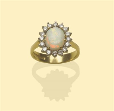 Lot 642 - A 18 Carat Gold Opal and Diamond Cluster Ring, an oval cabochon opal within a border of round...