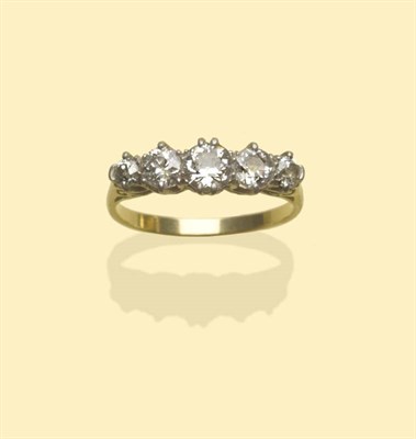 Lot 645 - A Graduated Diamond Five Stone Ring, the old cut diamonds in white claw settings, on a carved...