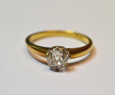 Lot 647 - A Diamond Solitaire Ring, the old cut diamond in a white eight claw setting, to a yellow plain...