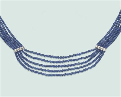 Lot 651 - A Sapphire and Diamond Necklace, five rows of graduated polished sapphire beads, with two...