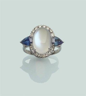 Lot 655 - An 18 Carat White Gold Moonstone, Sapphire and Diamond Cluster Ring, the oval cabochon moonstone in