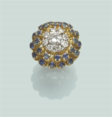 Lot 658 - An 18 Carat Gold Diamond and Sapphire Cocktail Ring, by Kutchinsky, a central round brilliant...