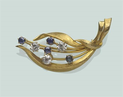 Lot 659 - A Sapphire and Diamond Spray Brooch, the yellow polished and textured form set with round brilliant