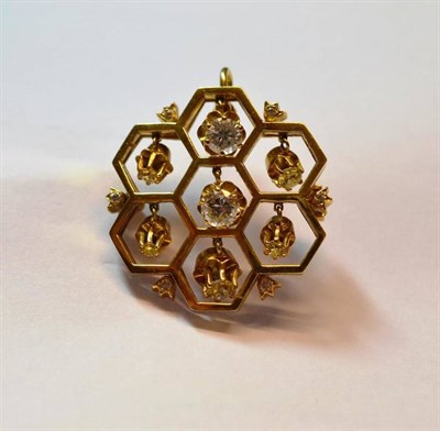 Lot 661 - An 18 Carat Gold Diamond Set Hexagonal Brooch/Pendant, of seven interlocking yellow hexagons...