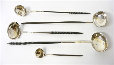 Lot 705 - A Group of Four Georgian and Later Silver Toddy Ladles, two with coins inset into the centre of the