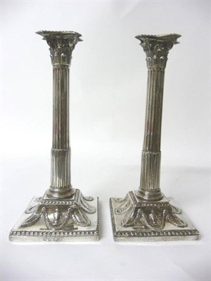 Lot 709 - A Pair of George III Corinthian Column Table Candlesticks, possibly John Carter II, London...