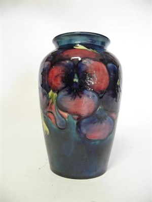 Lot 1126 - A William Moorcroft Pansy Pattern Vase, circa 1920's/30's, on a dark blue ground, impressed factory