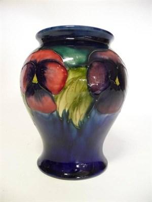 Lot 1127 - A William Moorcroft Pansy Pattern Vase, circa 1920's/30's, on a dark blue ground, impressed factory