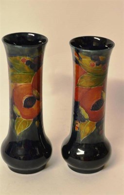 Lot 1128 - A Matched Pair of William Moorcroft Pomegranate Pattern Vases, on a blue ground, impressed...