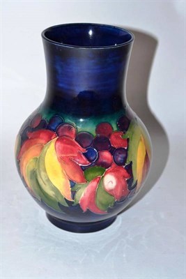 Lot 1129 - A William Moorcroft Leaf and Grape Pattern Vase, circa 1928-35, on a blue ground, impressed factory