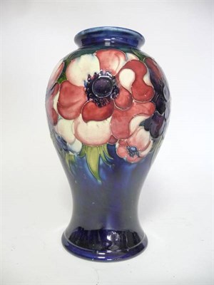 Lot 1139 - A Walter Moorcroft Anemone Pattern Vase, on a blue ground impressed factory marks and POTTER TO H.M