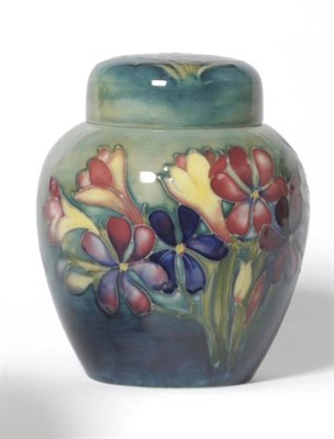 Lot 1140 - A Walter Moorcroft Spring Flowers Pattern Ginger Jar and Cover, circa 1947-57, on  a blue/green...