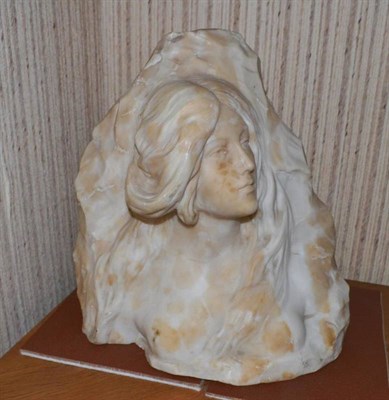 Lot 1195 - An Art Nouveau Alabaster Bust of a Nude Maiden, emerging from a rock, with long wavy hair, numbered