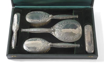 Lot 1206 - Omar Ramsden and Alwyn Carr: A Silver Five Piece Dressing Table/Brush Set, the backs with dog...