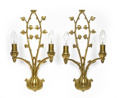 Lot 1211 - A Pair of W.A.S Benson Gilt Metal Two-Branch Wall Sconces, the arched stems with cast leaf...