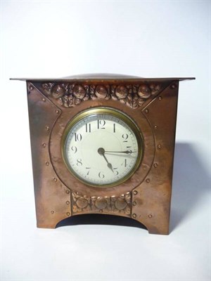 Lot 1216 - An Arts & Crafts Copper Cased Mantel Clock, of square form, with silvered dial, the case with...