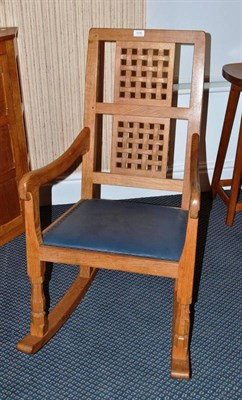 Lot 1230 - A Robert  "Mouseman " Thompson Oak Rocking Chair, with two lattice panel back, shaped arms,...