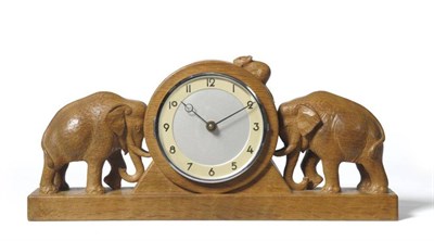 Lot 1238 - A Robert  "Mouseman " Thompson Oak Mantel Clock, the circular dial with a carved elephant to...