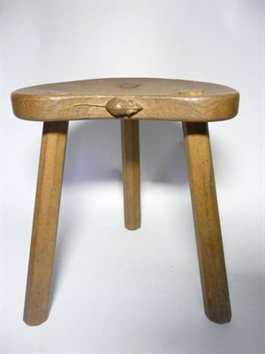 Lot 1254 - A Robert  "Mouseman " Thompson Oak Cow Stool, on three tapering octagonal legs, with carved...