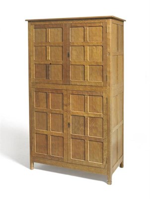 Lot 1269 - An Alan Grainger Acorn Industries Panelled Oak Linen Press, the upper section with two doors...