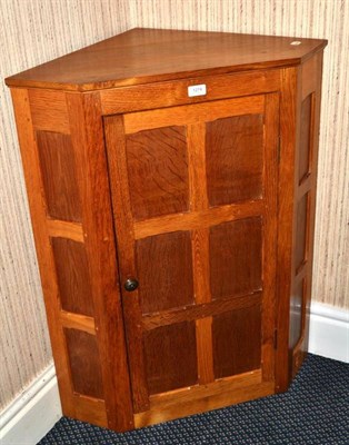 Lot 1274 - An English Hardwood Furniture Fumed English Oak Panelled Hanging Corner Cupboard, by Nigel...