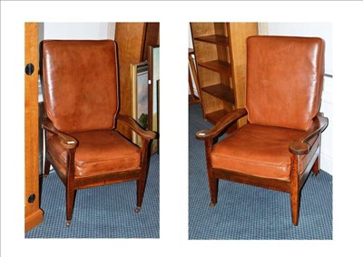 Lot 1289 - A Pair of Arthur W Simpson of Kendal Oak and Leather Armchairs, the curved nailed leather backs...