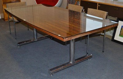 Lot 1297 - A 1960's Rosewood Table, the shaped rectangular top on two chrome cylindrical support with two...