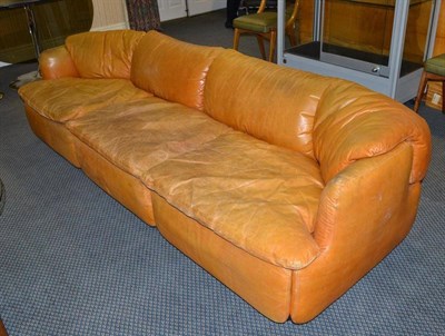 Lot 1304 - A Saporiti Orange Leather Three Seater Sofa, on three black plastic bases, moulded Saporiti,...