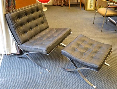 Lot 1305 - A Chromed Steel and Black Leather Barcelona Chair and Ottoman, after a design by Ludwig Mies...